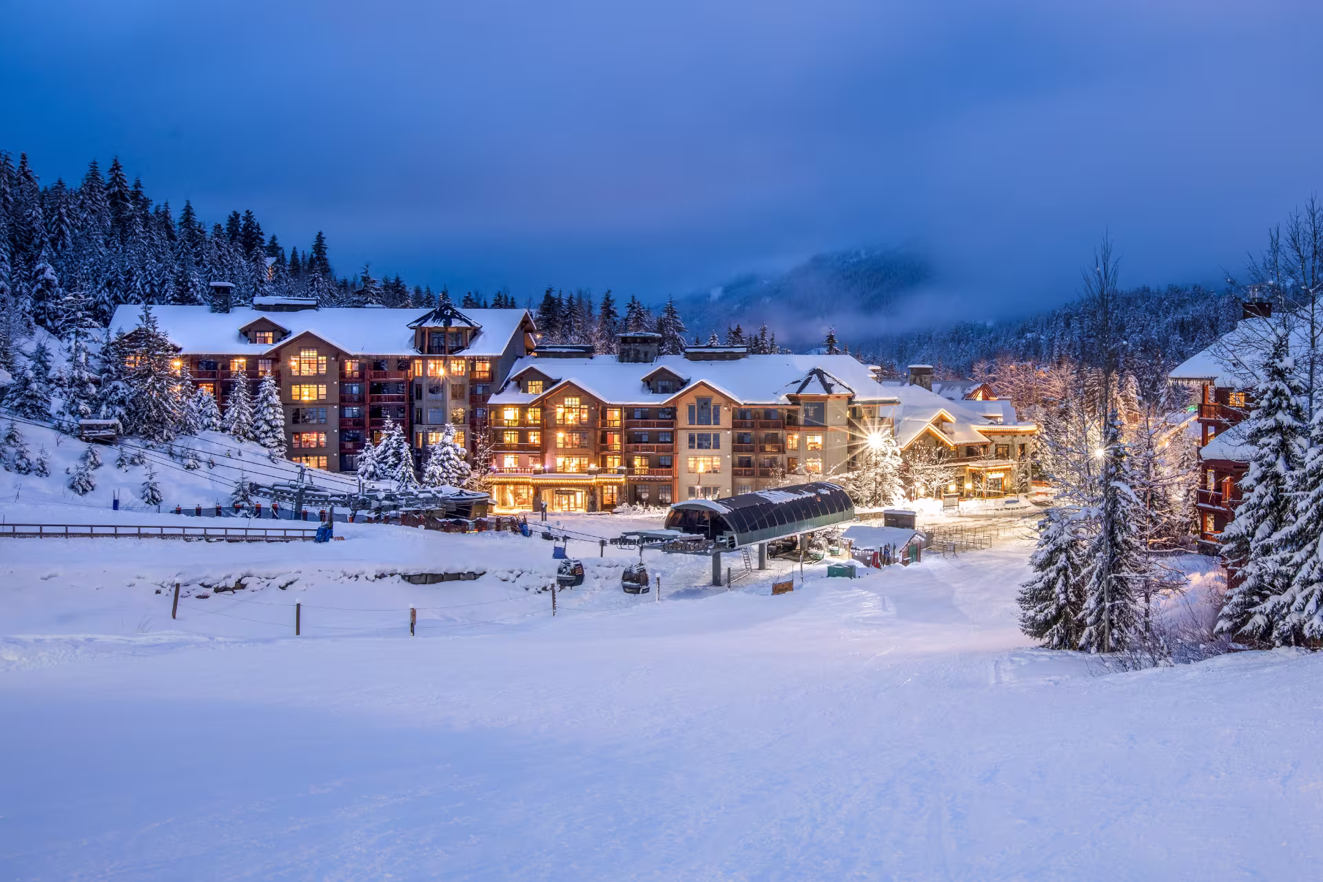 Snowy Whistler Creekside Gondola with First Tracks Lodge behind